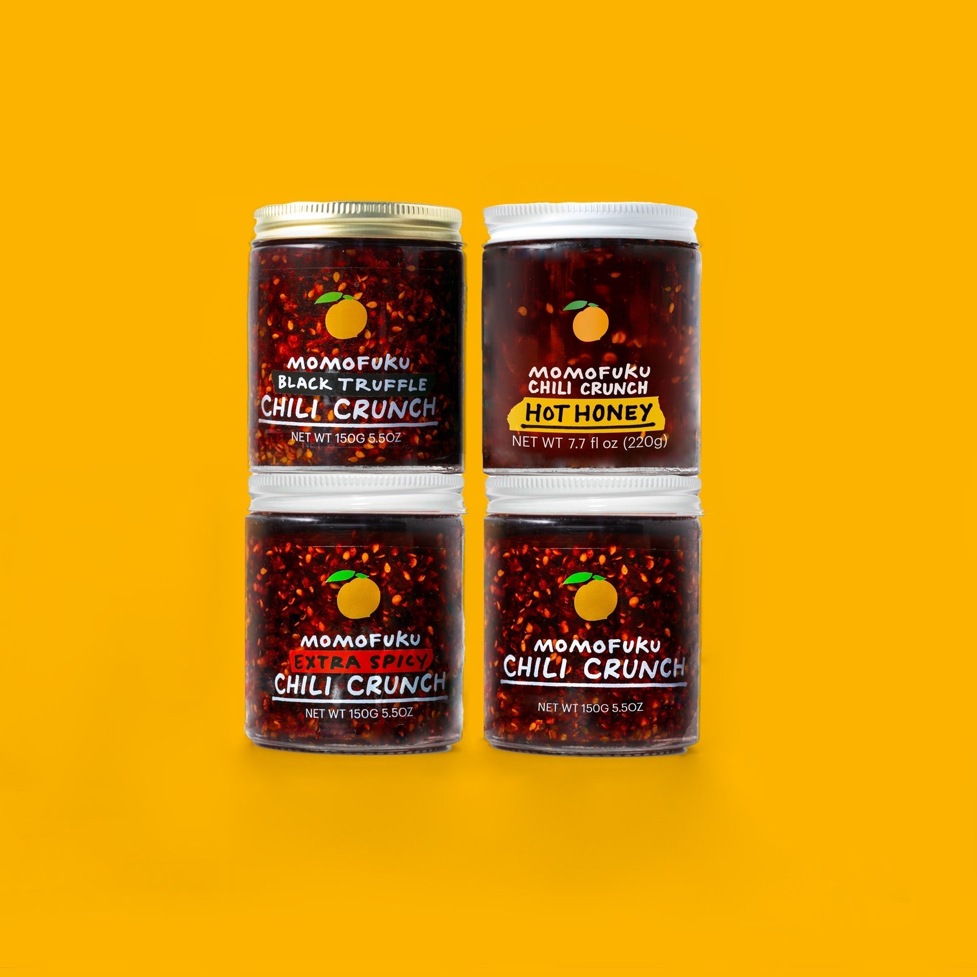 4 jars of chili crunch on yellow background