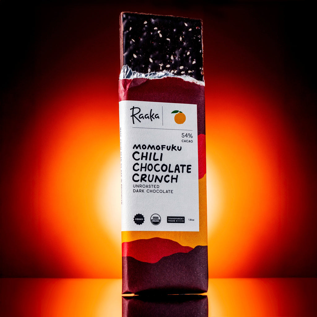 Raaka Momofuku Chili Chocolate Crunch packaging on a dark background