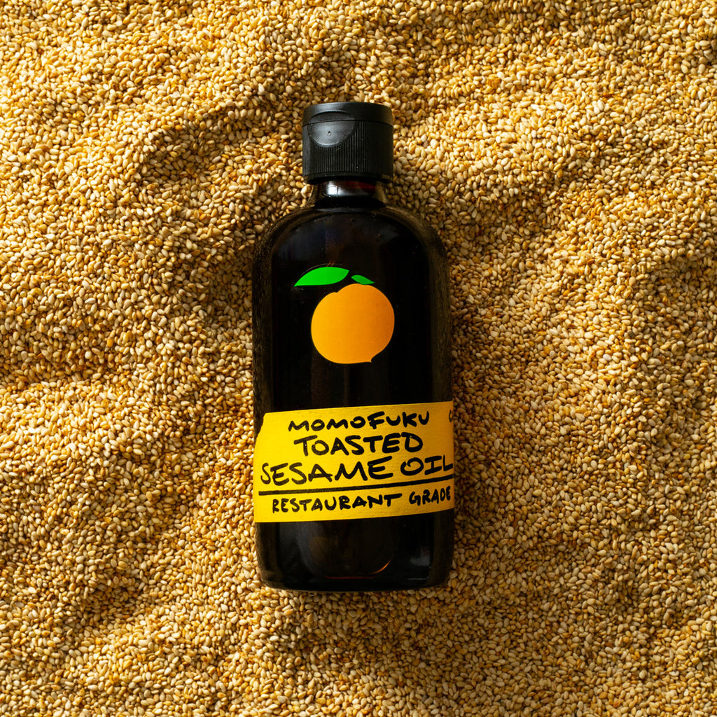 Bottle of Toasted Sesame Oil on a bed of sesame seeds