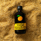 Bottle of Toasted Sesame Oil on a bed of sesame seeds