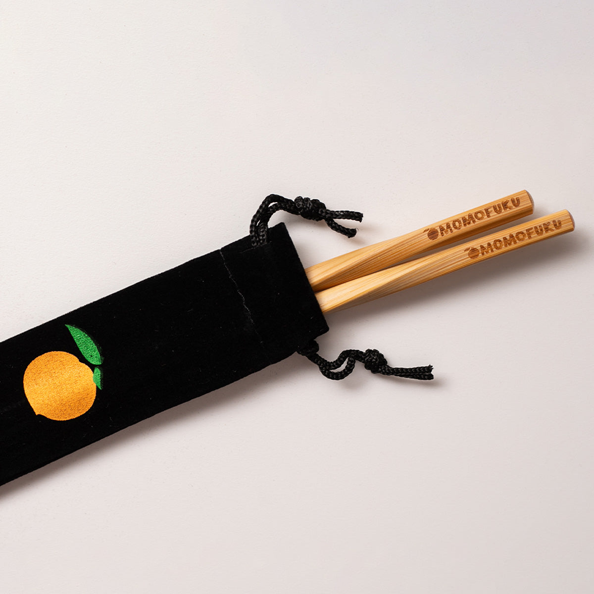 pair of momofuku chopsticks in velvet pouch