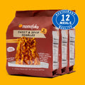 Momofuku Sweet & Spicy Noodles packaging on a yellow background with '12 Meals Quality' badge.