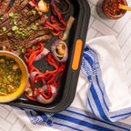 sheet pan with skirt steak and kitchen towel
